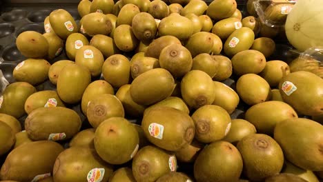 fresh kiwis neatly arranged in supermarket display