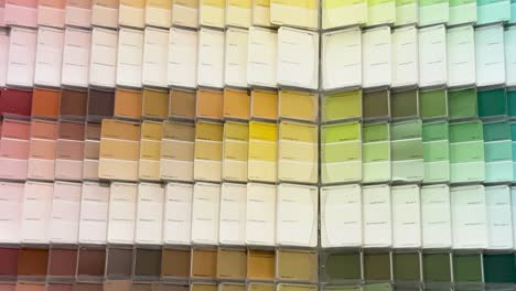 A close-up view of colorful paint swatches arranged in a hardware store display.