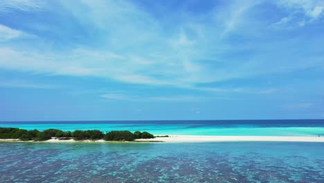 Paradise-holiday-scenery-with-tropical-island-cape-of-white-sandy-beach-surrounded-by-calm-turquoise-lagoon-with-coral-reefs-under-veil-of-clouds-in-Bora-bora