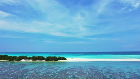 paradise holiday scenery with tropical island cape of white sandy beach surrounded by calm turquoise lagoon with coral reefs under veil of clouds in bora bora