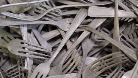 Vintage-forks,-kitchen-cutlery-close-up,-old-tarnish-covered-flatware-background