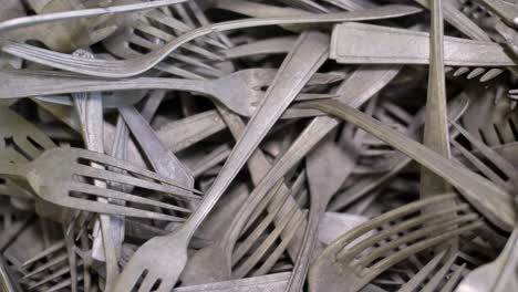 vintage forks, kitchen cutlery close up, old tarnish covered flatware background