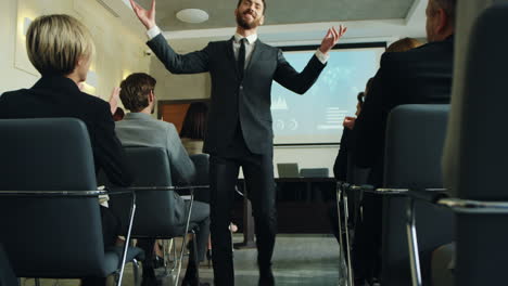 cheerful caucasian businessman finishing his report in front of his colleagues and going away while throwing documents and sheets of paper up