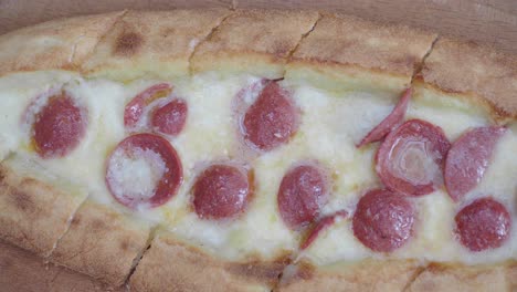 close-up of a turkish pide with cheese and sausage