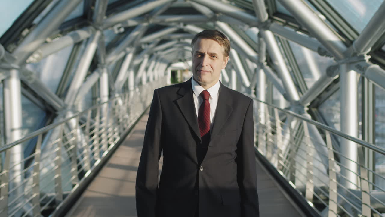 Successful Middle-Aged Business Man Standing At Glass Bridge