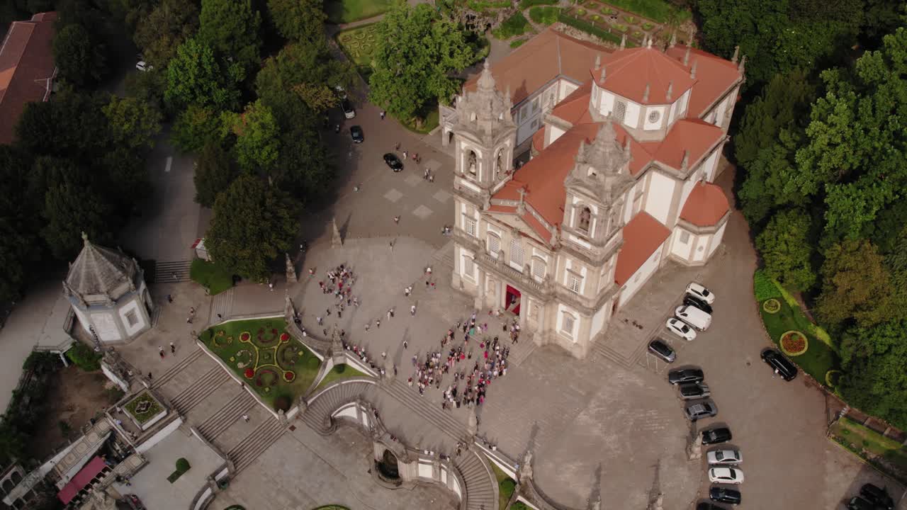 aerial - crowds and cars gather at Bom Jesus do Monte church in Braga Portugal