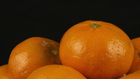 Macro-closeup:-Bright-orange-stack-revolves-against-black-background