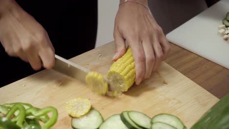 Women-slicing-vegetables-in-kitchen