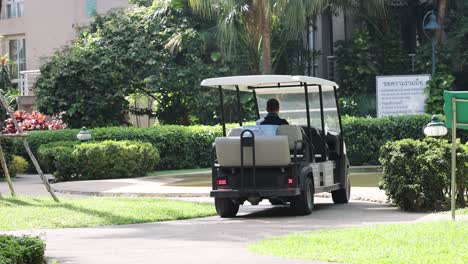 a golf cart moving along a garden path