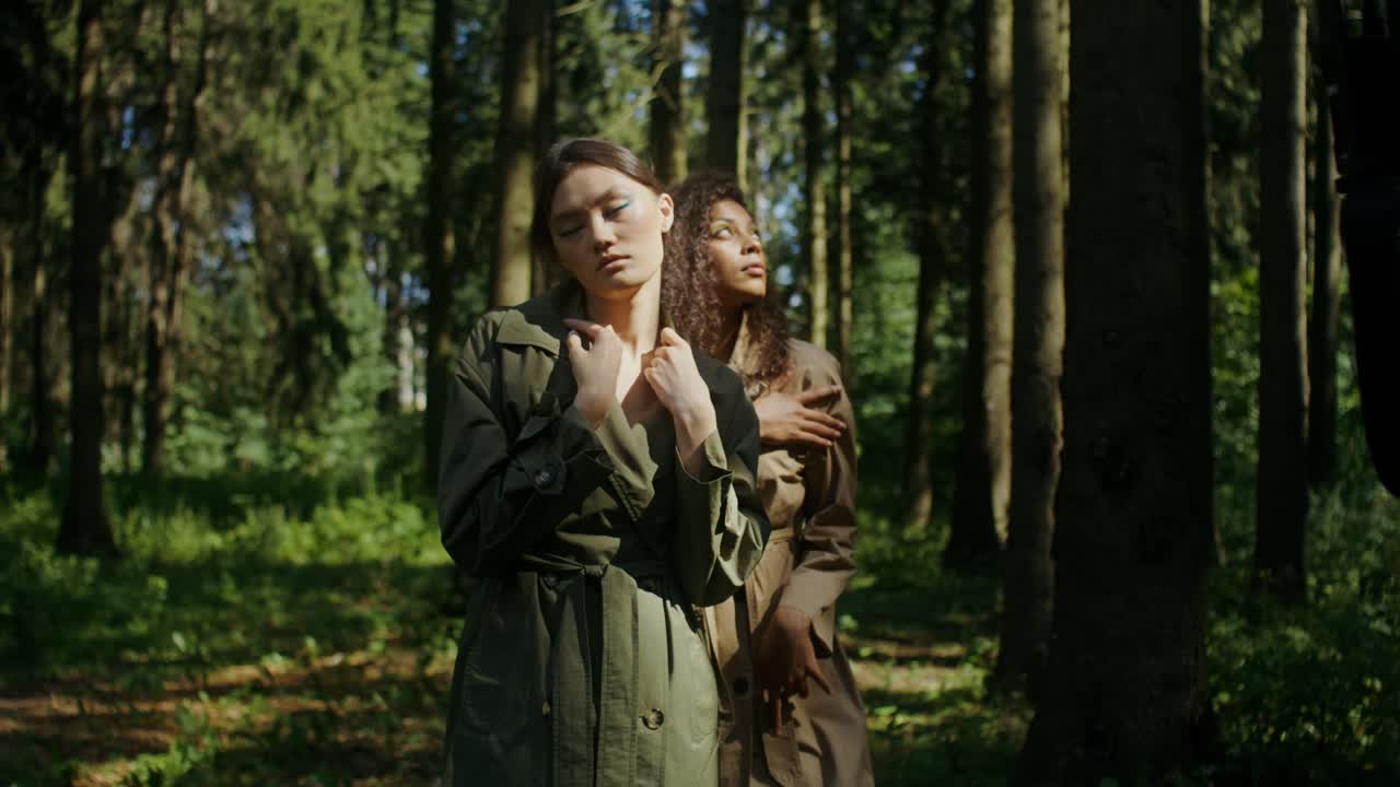 Two Women in Trench Coats in a Forest