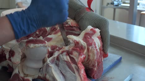 butchering raw beef carcass