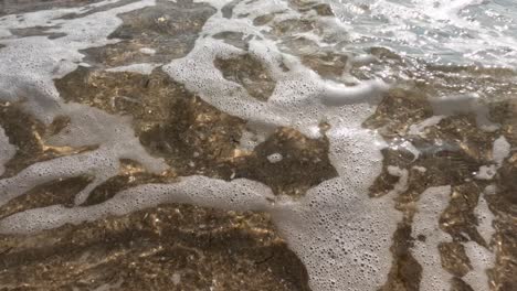 waves gently washing over sandy shore