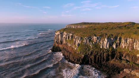 epic aerial view near high cliffs on the ocean at sunrise