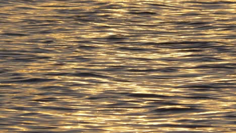 dreamy golden hour water reflections on turbulent ocean flow - static shot