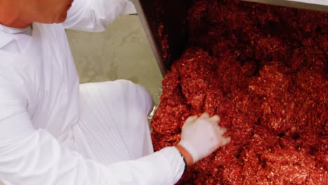 Butcher-preparing-minced-meat