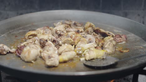 chicken cooking in a large pan