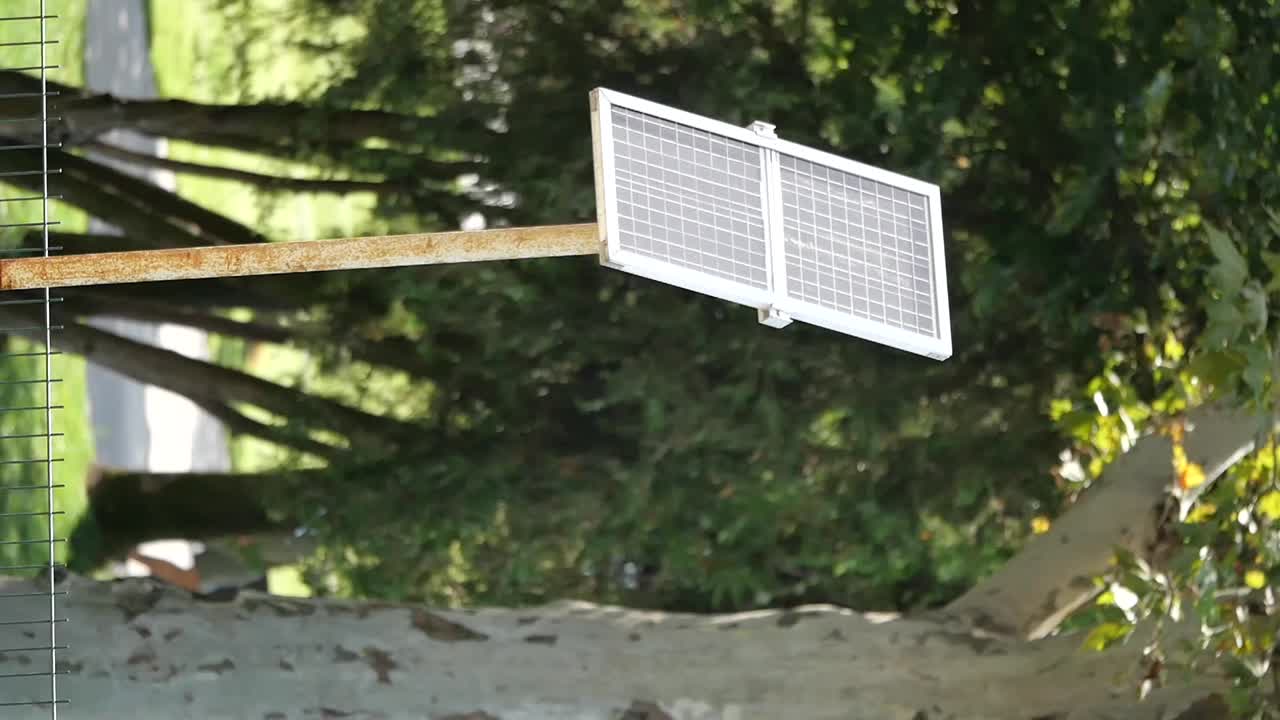 Solar panel on a metal pole in a natural setting