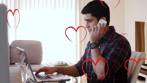 Animation-of-falling-hearts-icons-over-biracial-men-using-laptop