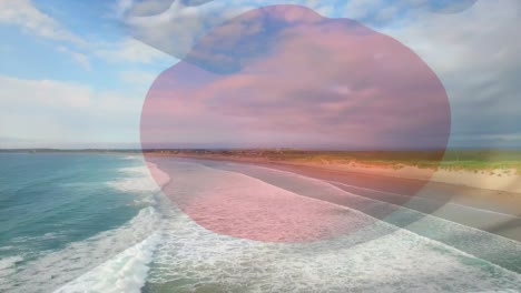 animazione della bandiera del giappone che soffia sul paesaggio della spiaggia