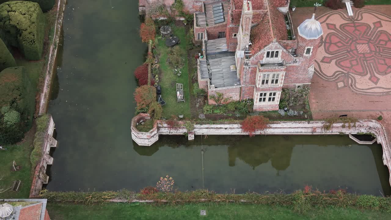 Kentwell hall aerial view overlooking grand Tudor manor moat and rose mosaic courtyard property