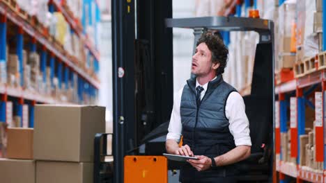 male warehouse worker using digital tablet