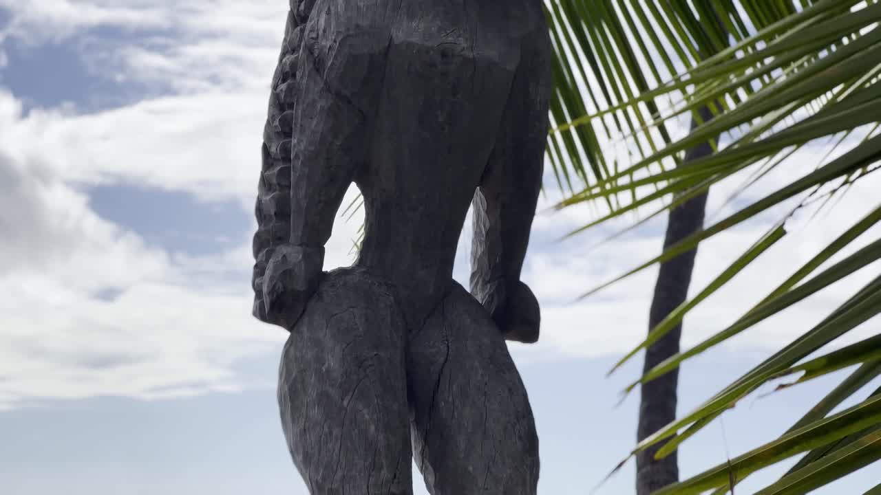 Cinematic close-up booming up shot of a tiki statue at Pu'uhonua O Honaunau National Historical Park in Hawai'i