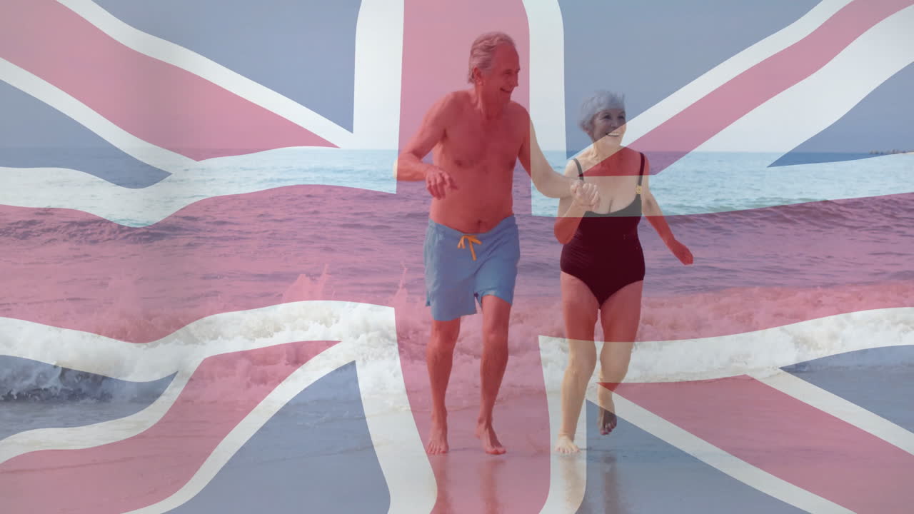 Animazione della bandiera Union Jack su coppia anziana che cammina sulla spiaggia