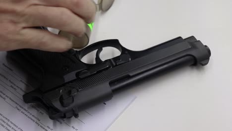 person taking a handful of sleeping tablets then picks up a black firearm with divorce papers left visible on the table