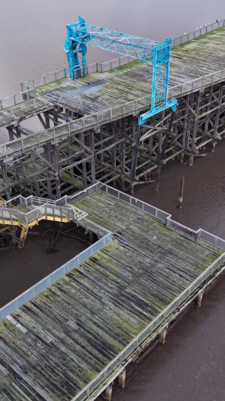 Close-up cinematic of Dunston Staiths, showing deteriorating timber, old loading cranes and support beams - Gateshead, UK