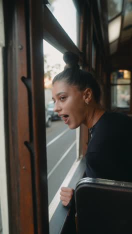 woman on a train looking out the window