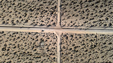 car driving on dirt road in the desert at joshua tree national park in california