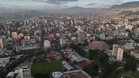 Aerial-drone-video-view-footage-of-Qutio-early-morning-sunrise-capital-city-of-Ecuador-La-Carolina-Park-traffic-Catedral-Metropolitana-de-Quito-south-american-skyline