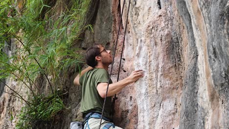 climber scaling a cliff at railay beach