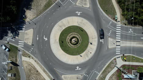 Downward-angle-drone-shot-of-a-round-about-traffic-circle