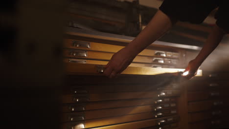 person working in a wooden archive