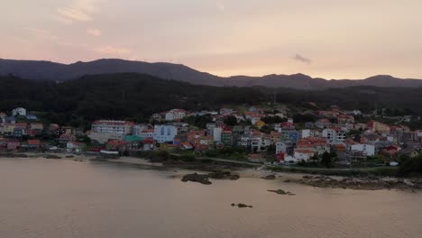 Establishing-shot-of-picturesque-coastal-village-in-golden-hour