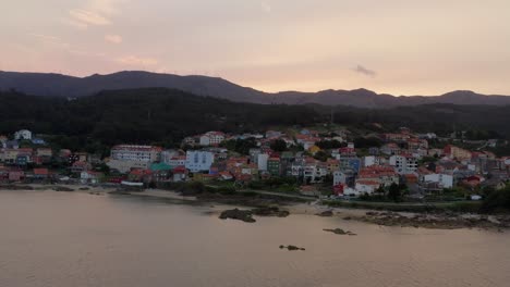 establishing shot of picturesque coastal village in golden hour