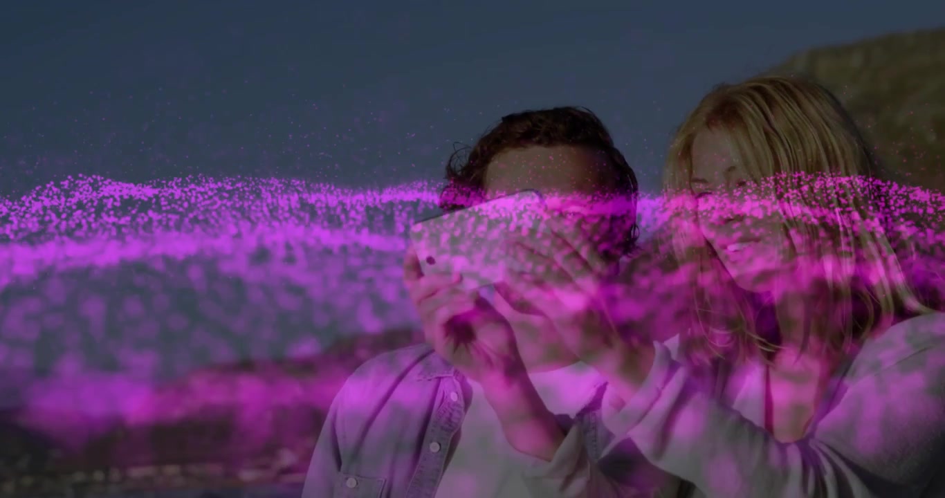 Woman lifting phone, couple framing and checking selfie, pink wave overlaying them for social media