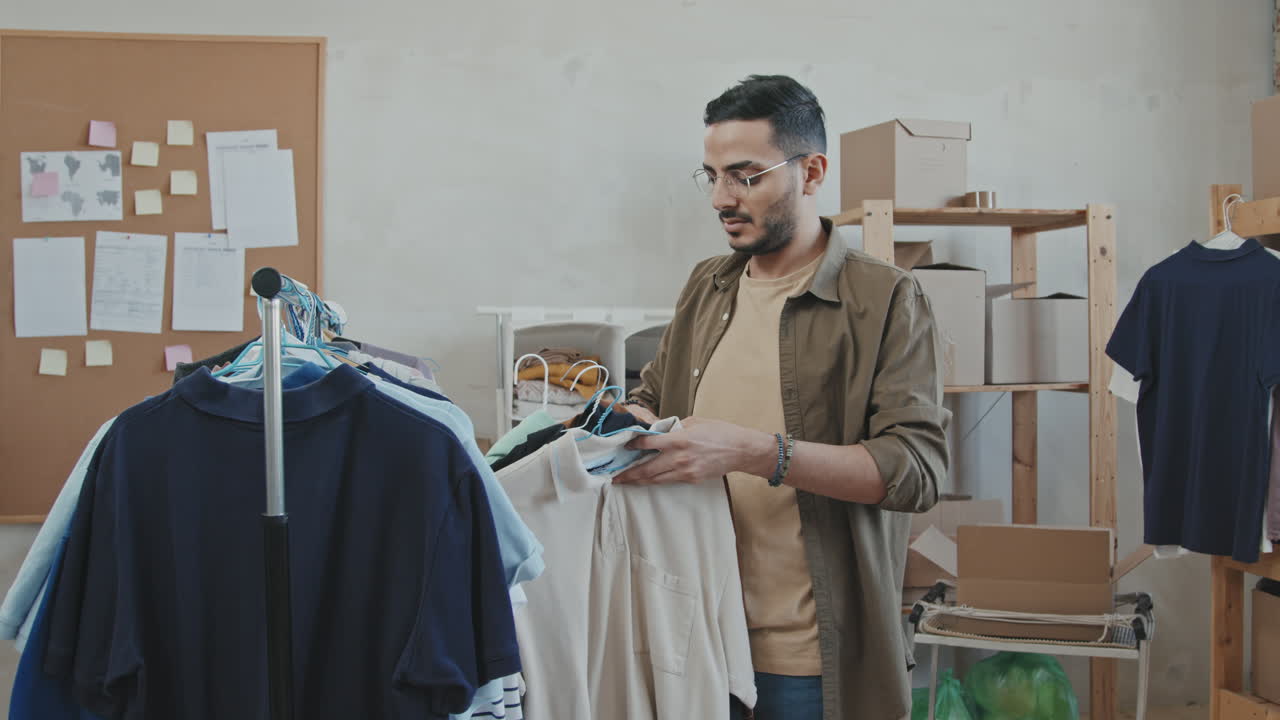 Volunteer Hanging Donated Clothes on Railing