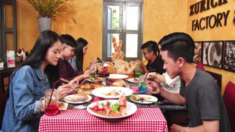 happy friends enjoying food in restaurant, video 4k