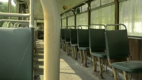 interior of abandoned antique school bus, truck left shot