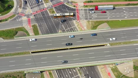 Top-view-over-the-highway,-expressway-and-motorway,-Aerial-view-interchange-with-car-driving-down-the-highway