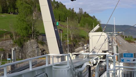 Charging-cable-automatically-coming-down-and-electric-ferry-starts-charging-at-Hella-ferry-pier-in-Sognefjorden-Norway