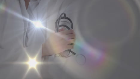 animation of light spots over caucasian doctor with stethoscope