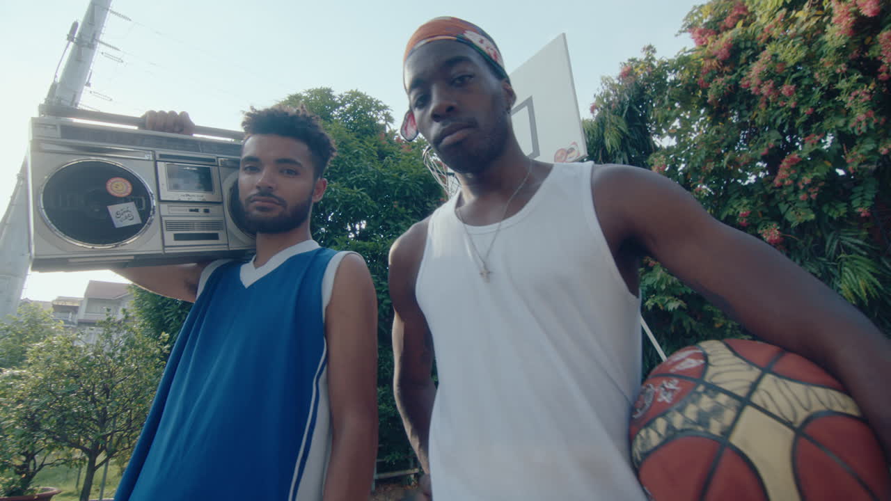 Two Basketball Friends Posing with Boombox and Ball on Playground