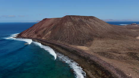 fantastic orbit aerial shot on a sunny day of the volcano of the island of wolves, in the canary islands