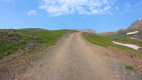 pov driving up black bear pass trail, driving on a gravel trail through alpine meadow in san juan mountains near telluride colorado