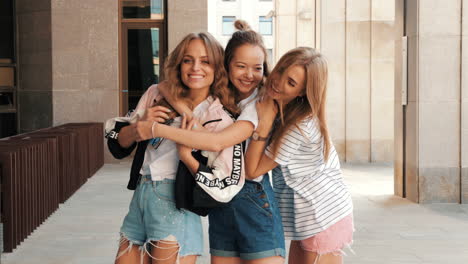 three friends hugging outdoors