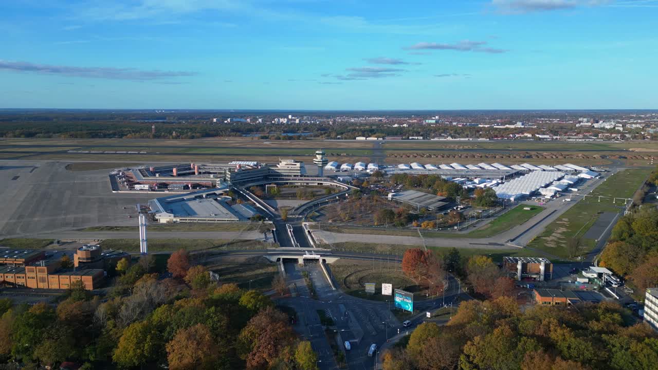 berlin tegel airport showing the main terminal, control tower, hangars. Now Refugee home. Marvelous aerial view flight ascending drone