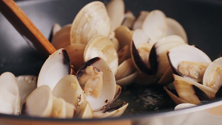 Marinara mussels with garlic, sauce, lemon and parsley. Classic spanish and French meal macro close up.